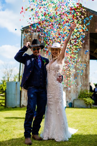 bride and groom being showered with confetti after wedding