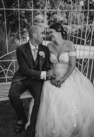 Wedding couple black and white photo on bench at Southdowns Manor West Sussex