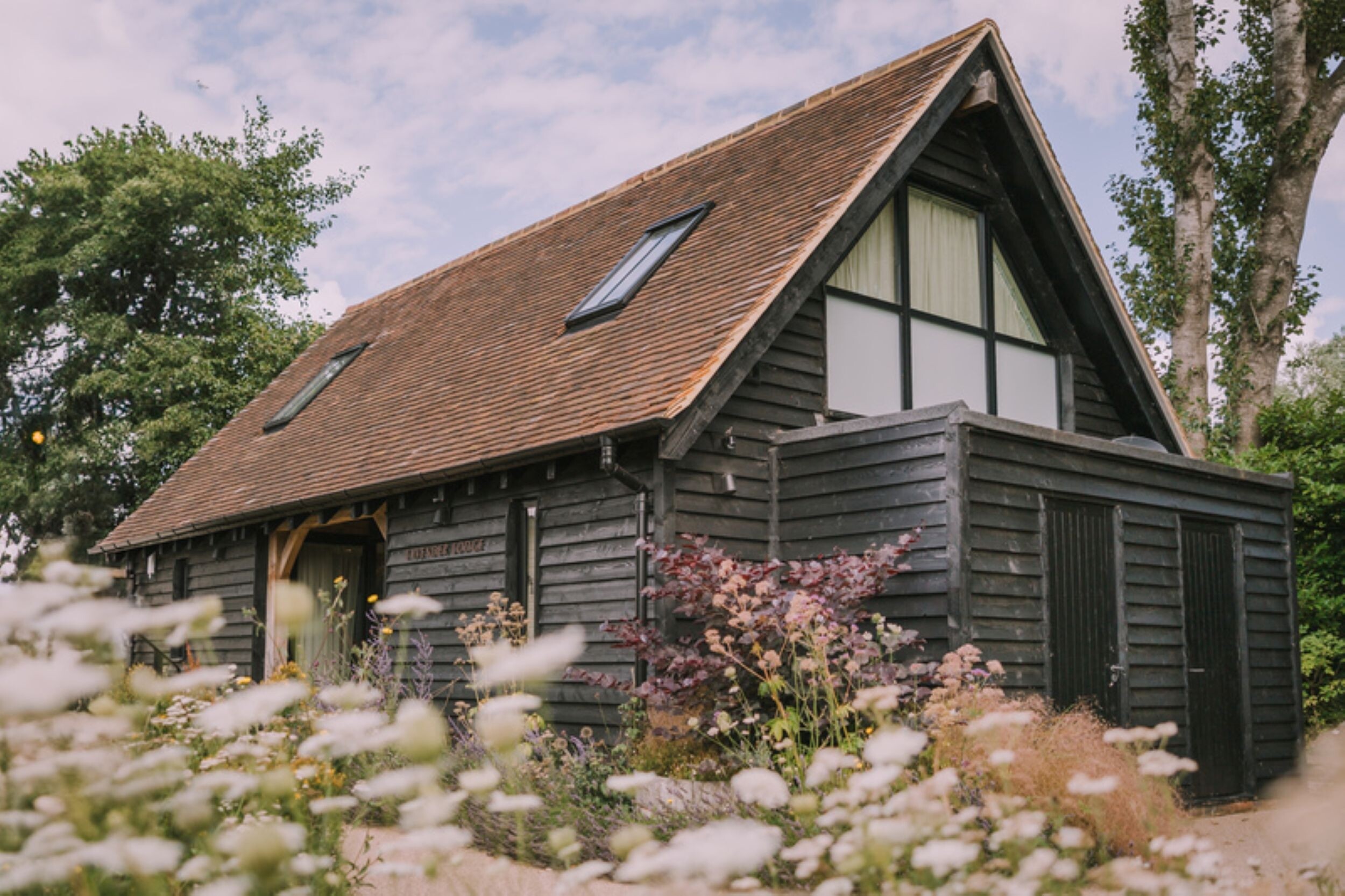 Exterior of Lavender Lodge, the honeymoon cottage at Alfriston Gardens - an exclusive use wedding venue in East Sussex
