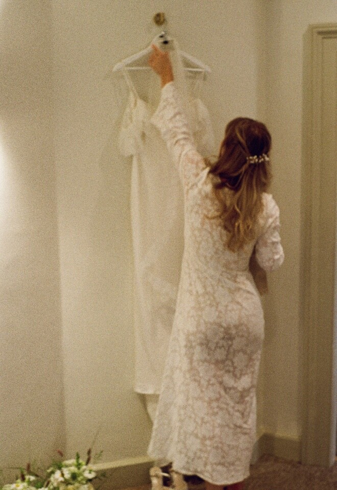 Bride getting ready to put on her wedding dress