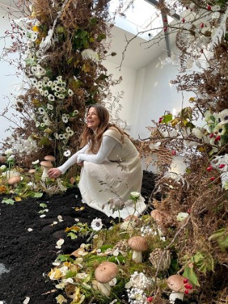 Florist, Sophie, underneath natural floral arch creation