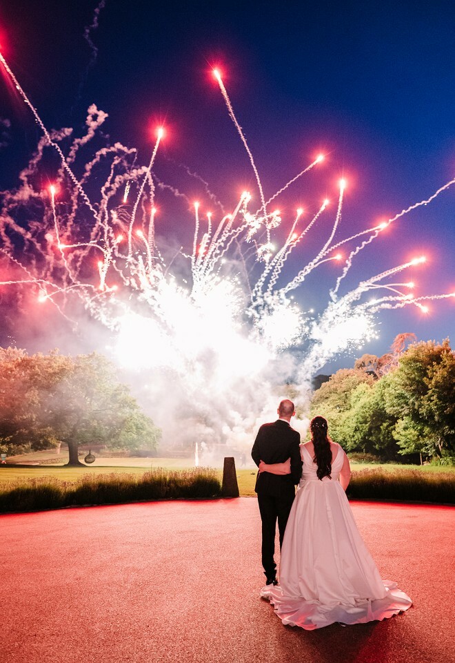 Alison and Martyn watching fireworks at their wedding at Clevedon Hall