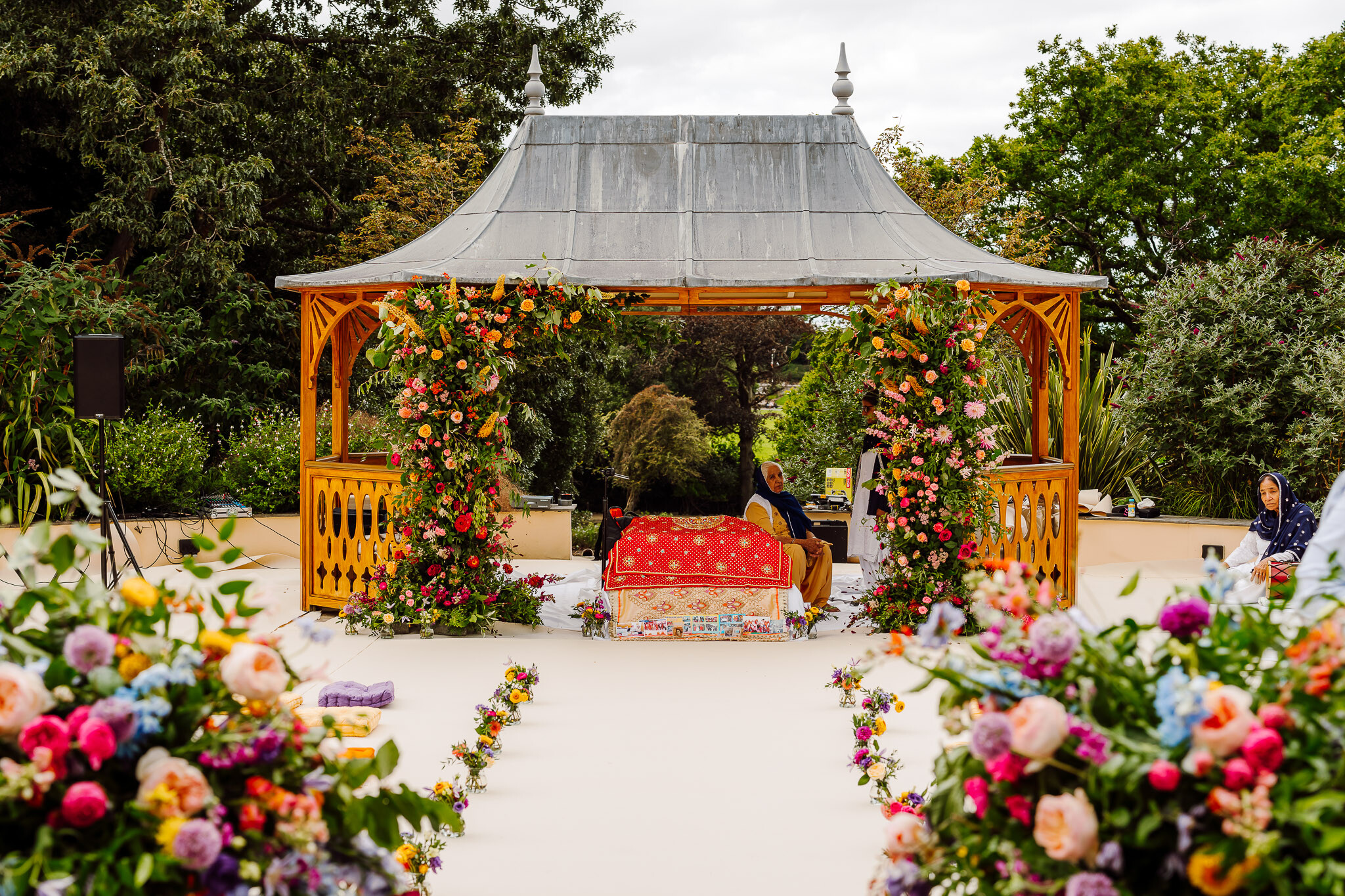 Colourful statement wedding ceremony floral arrangements for a Sikh wedding ceremony 