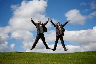 Groom and best man jump for joy  at St Mellion Estate