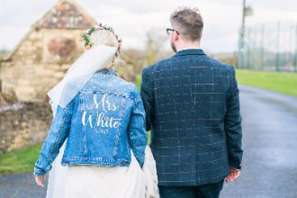 bride and groom walking down venue driveway