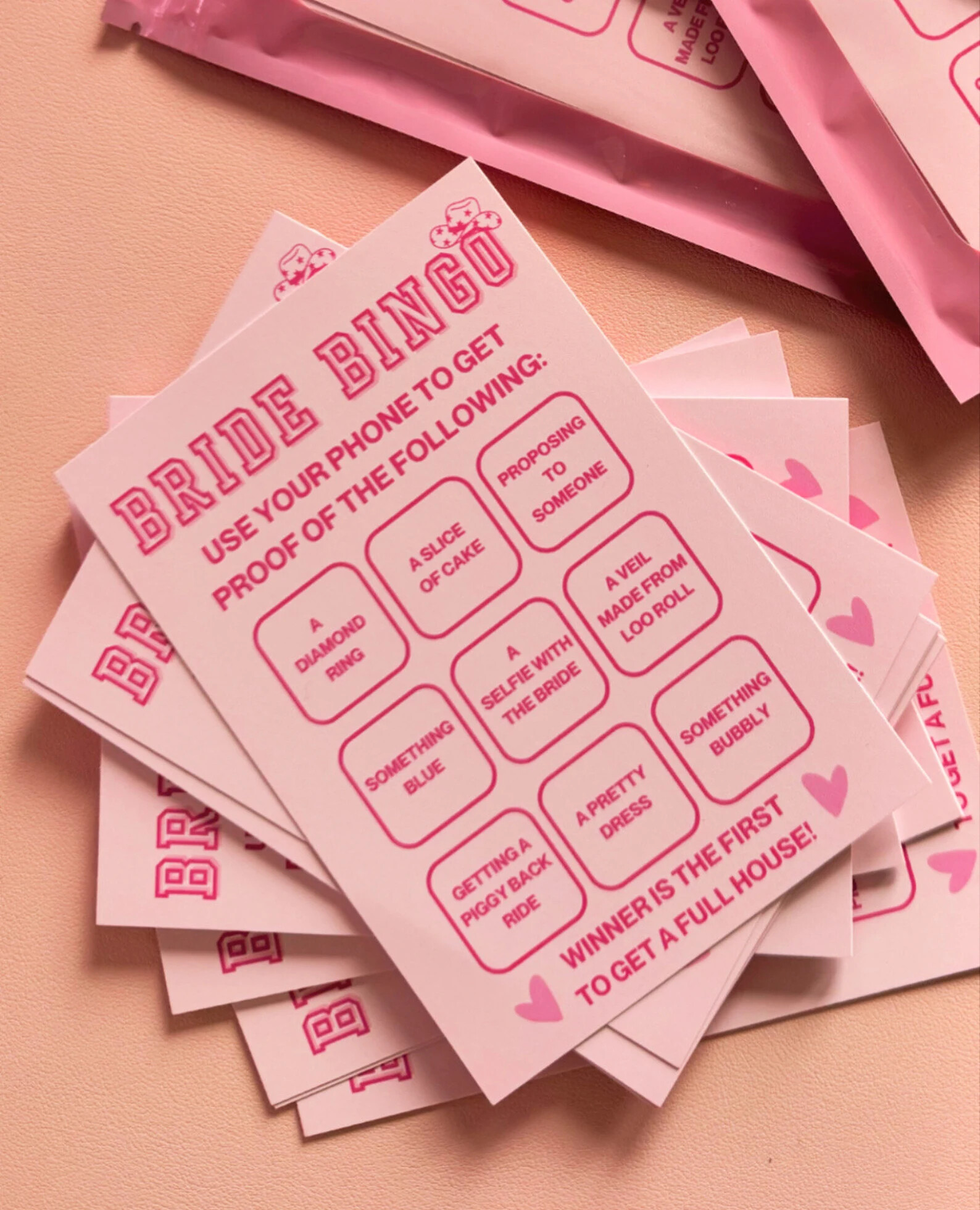 pink barbie bingo card with different activities to tick off