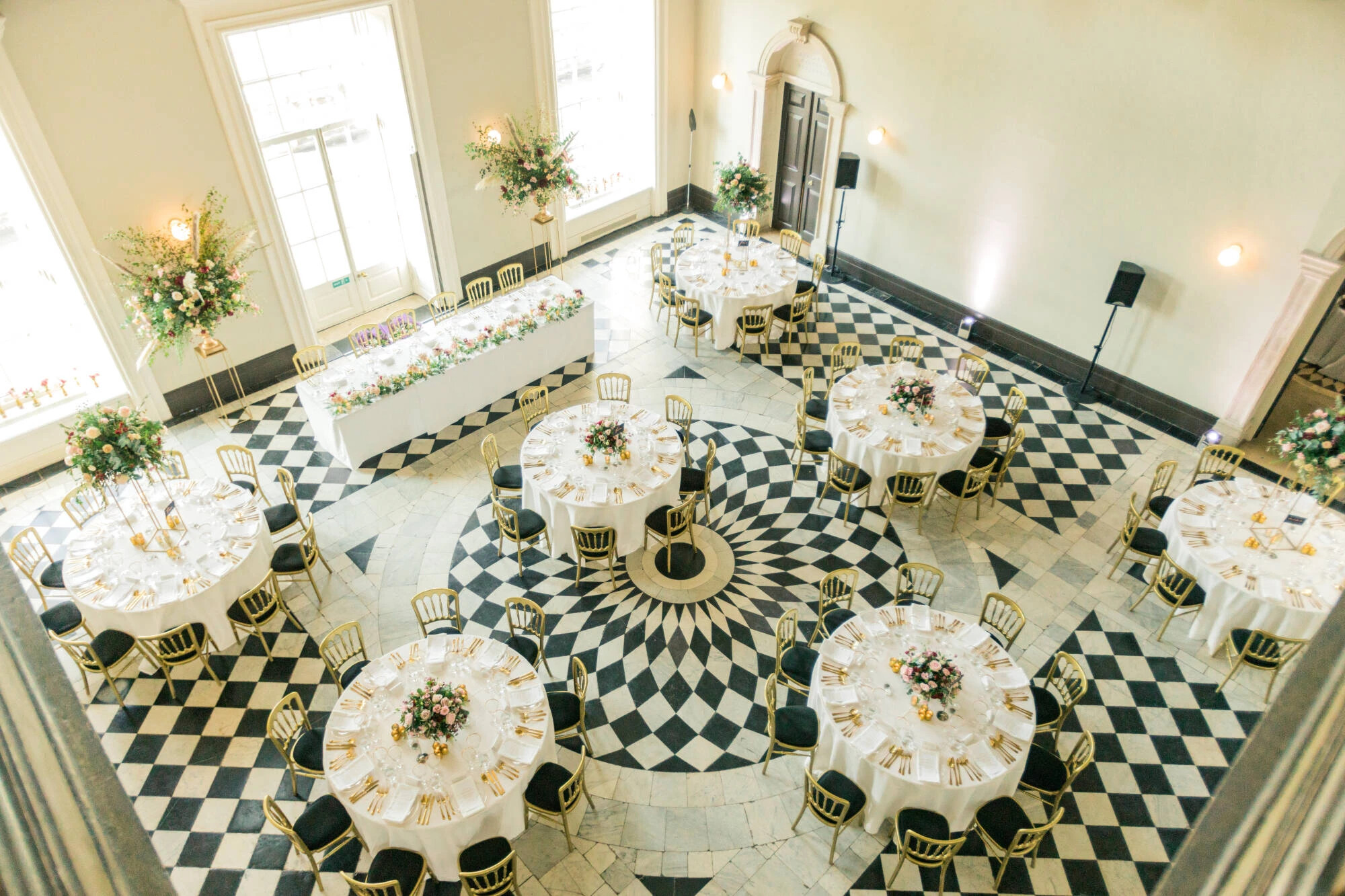 Aerial photograph of tables inside the Queens House set for a wedding breakfast.