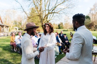 Wedding couple at outdoor ceremony exchanging rings
