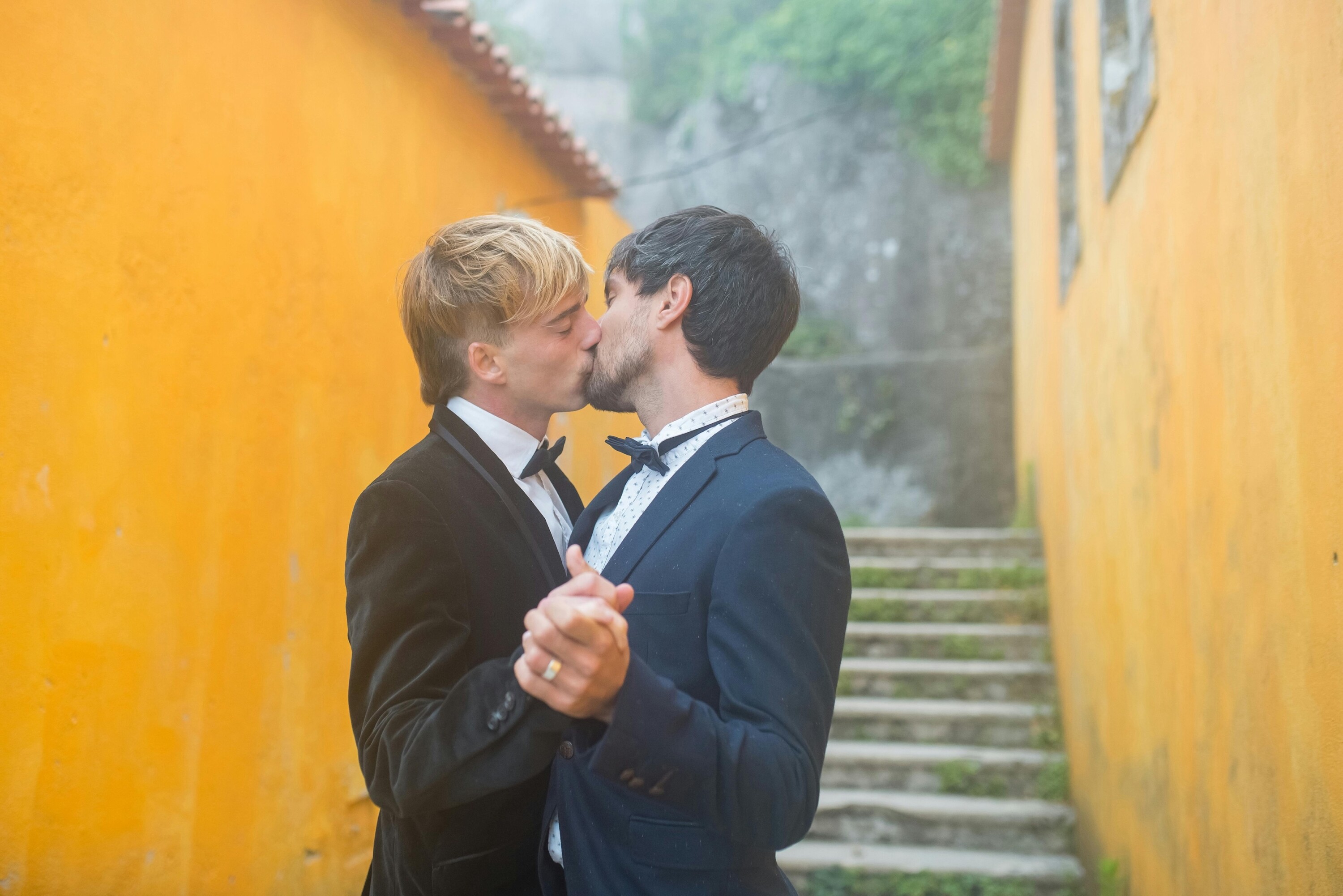 Groom and groom kiss on their wedding day