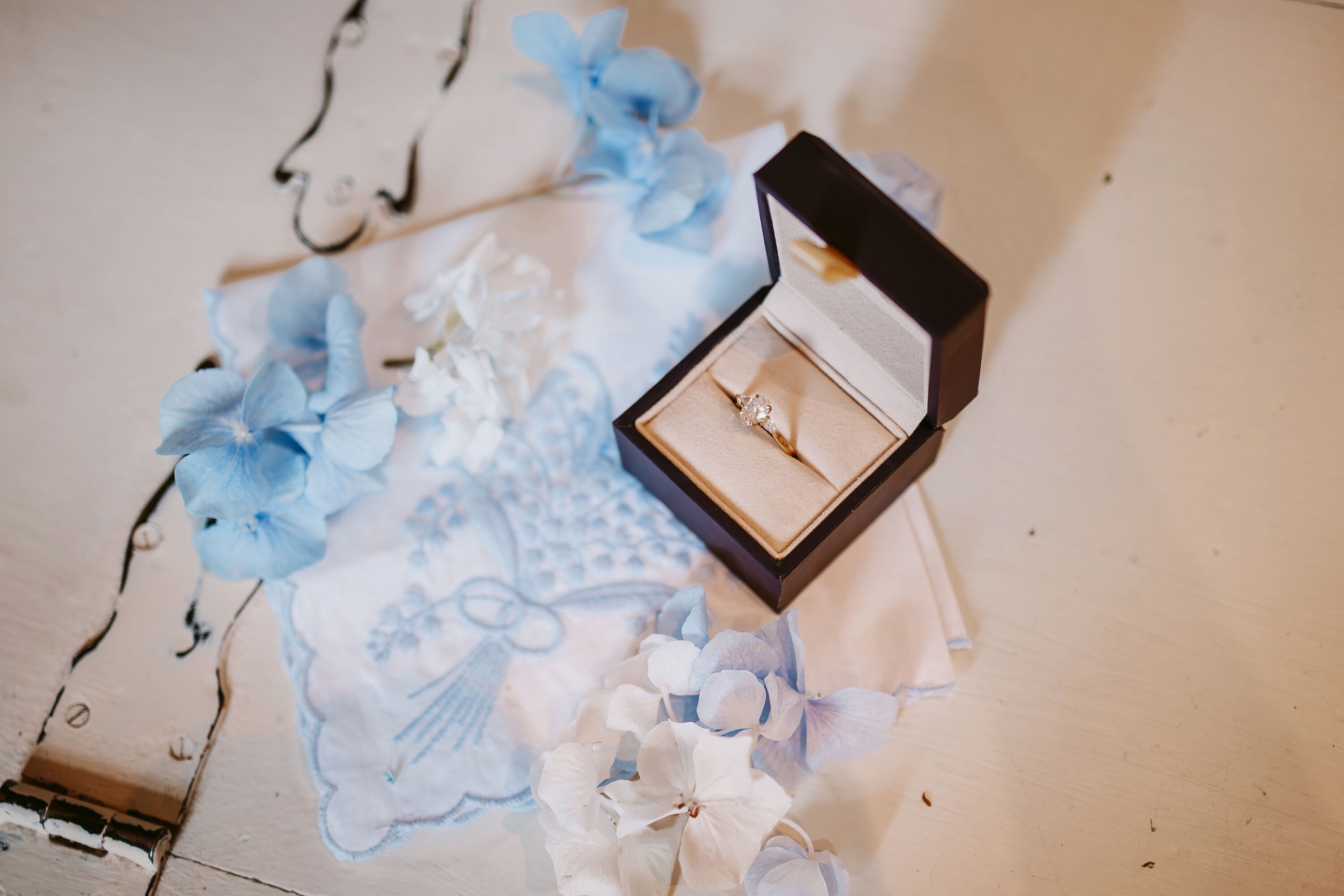 Gold engagement ring with oval cut diamond in a box