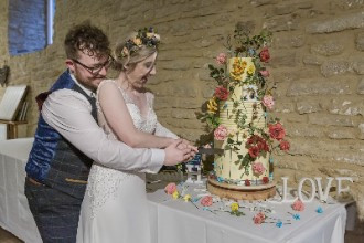 Bride and groom cutting cake