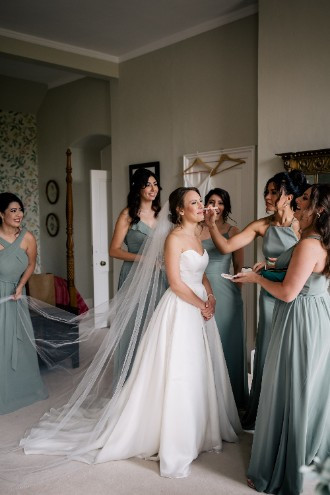 Bride touching up make up at Ardington House