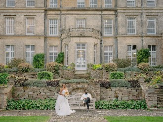 Bride and Groom posing outside Hedsor House