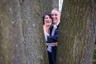 bride and groom through the trees