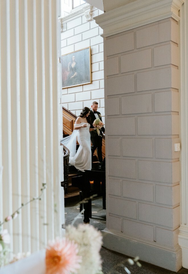 Bride and groom walking down the staircase at Davenport House