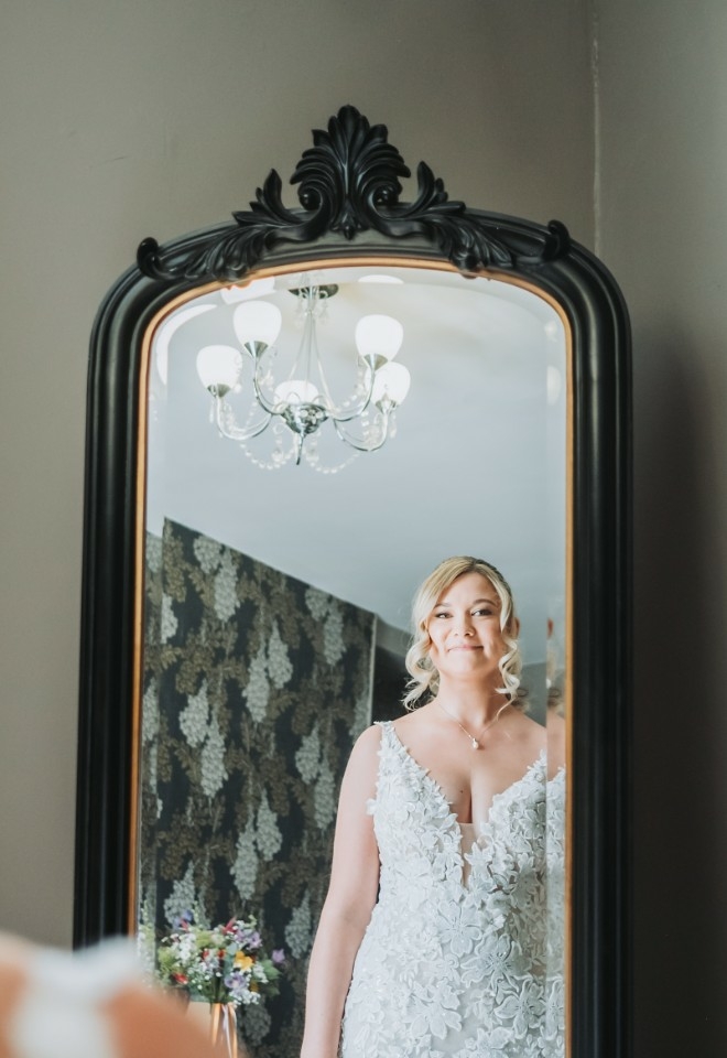 Rosie admiring herself and her dress in the mirror
