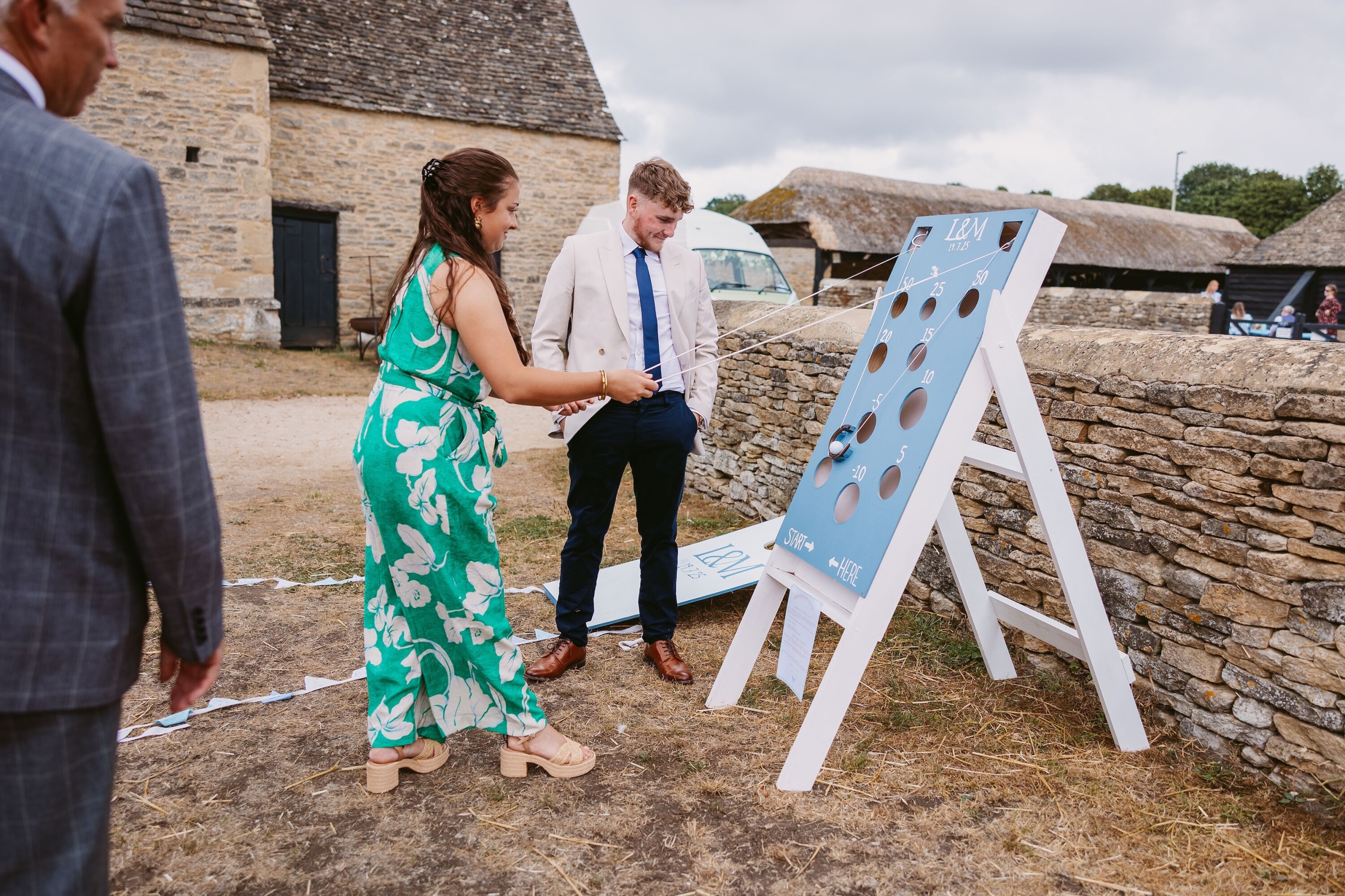 guests playing garden games at wedding reception at cogges manor farm