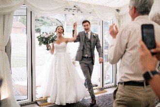 Bride and Groom entering Ardington House Wedding Marquee