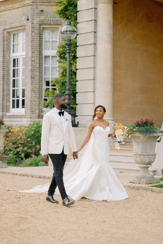 Bride and Groom walking outside of Hedsor House