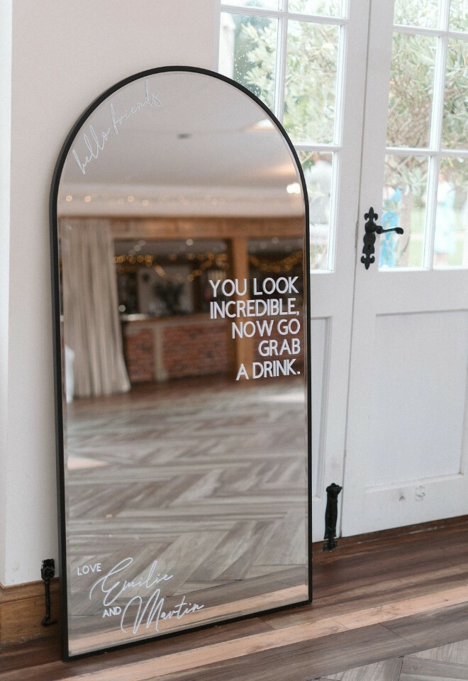 Mirror in Elmhay Park Orangery with signage that reads "Hello friends. You look incredible, now go grab a drink. Love Emilie & Martin"