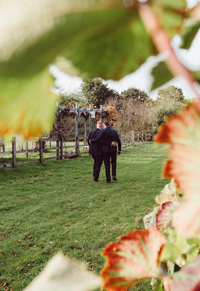 Wedding couple walking through grounds at Copdock Hall wedding venue Suffolk