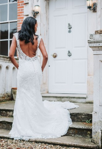 A photo taken of the back profile of the bride on the front steps of Ardington House