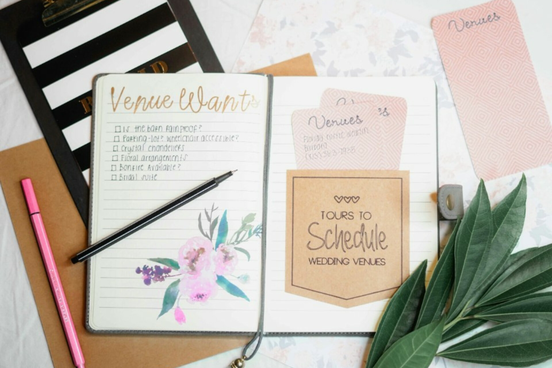 Wedding planning notebook with venue checklist and notes for organising a wedding budget