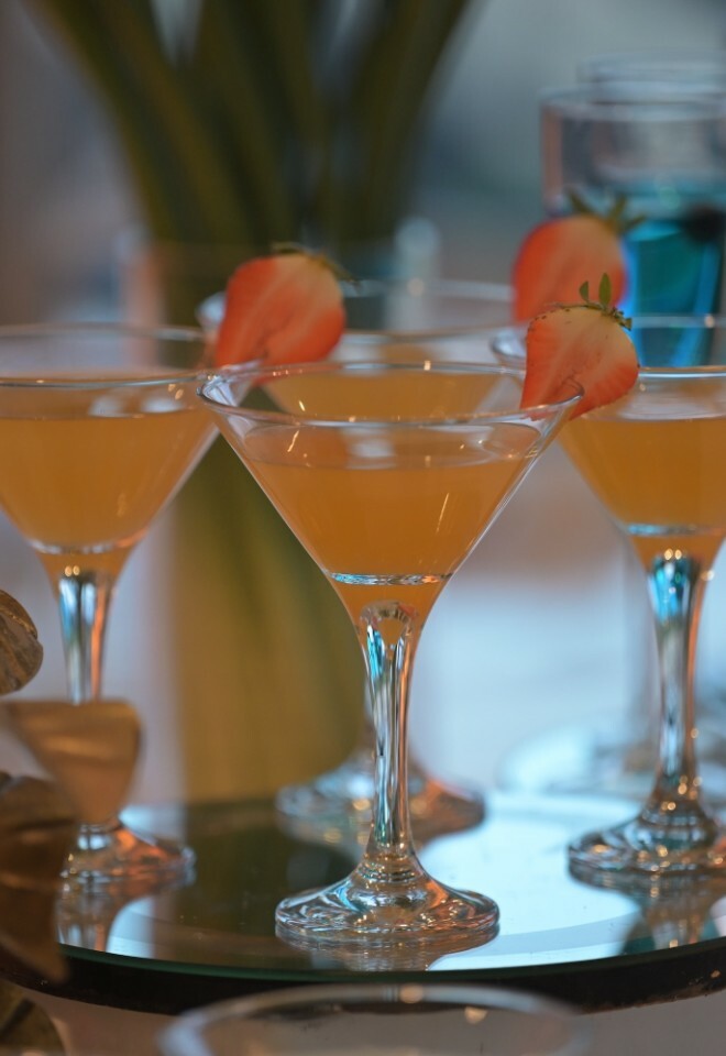 Orange coloured drinks kept on a glass tray