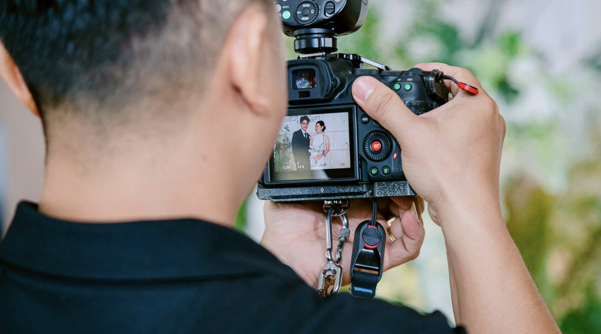 A man videoing a married couple