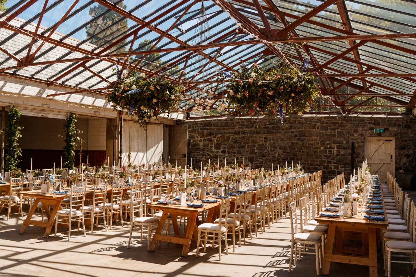 Plas Dinam Stables Barn with glass roof set for a wedding breakfast with tressel tables
