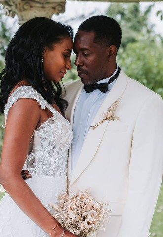 Bride and groom embracing each other in the Island Temple, with their foreheads touching.
