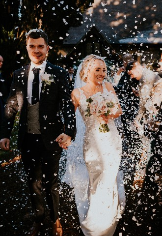 Bride and groom confetti moment at Hedsor House wedding venue Buckinghamshire