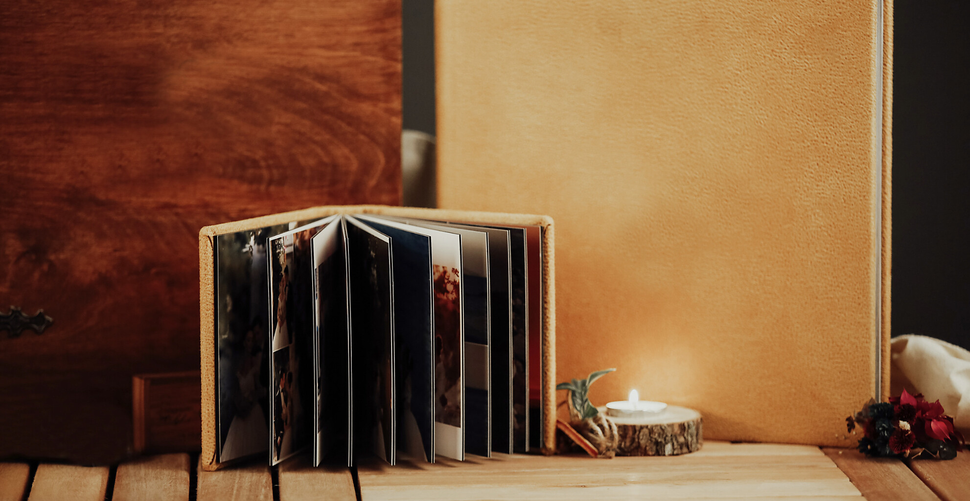 Image of a wedding album next to a candle
