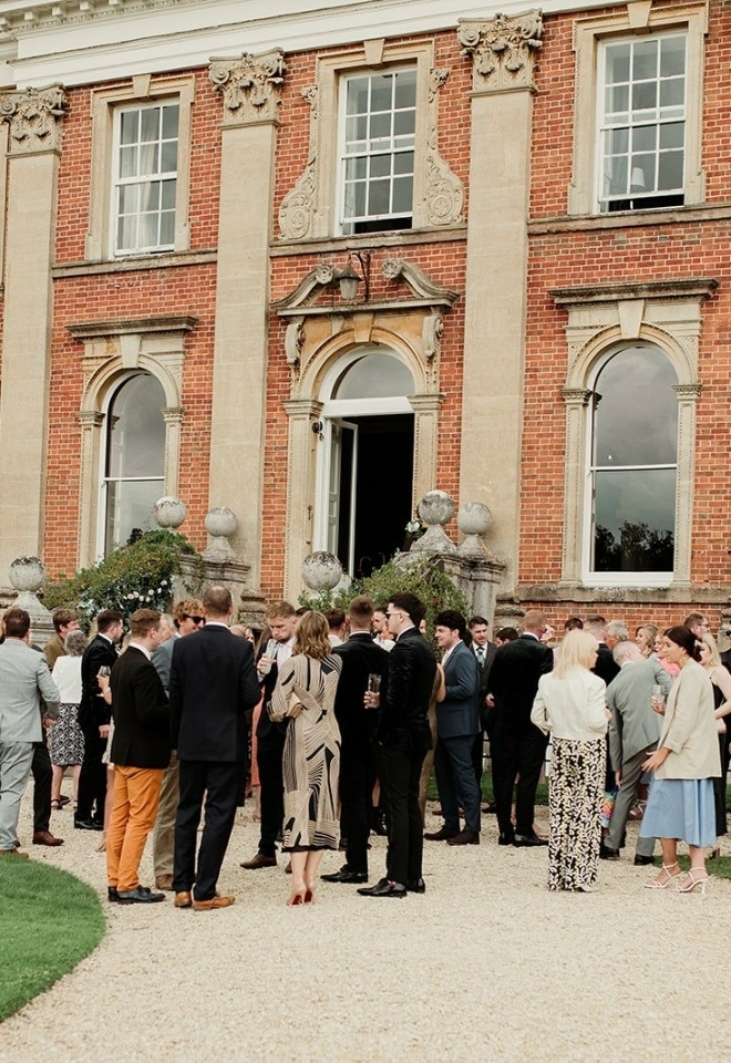 Wedding guests gathered outside Crowcombe Court