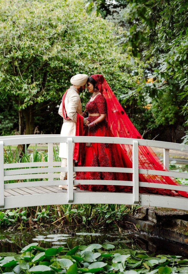 Bride and Groom posing on top of a bridge