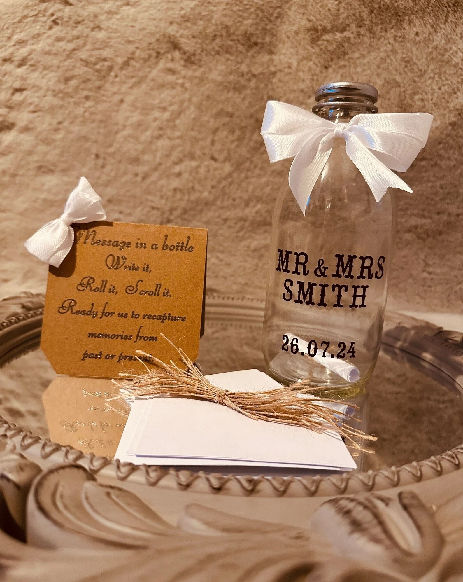 Message in a bottle guest book alternative with a personalised glass bottle, where guests write notes, roll them up and place them inside as a keepsake.