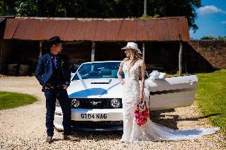 Bride and groom with Ford Mustang