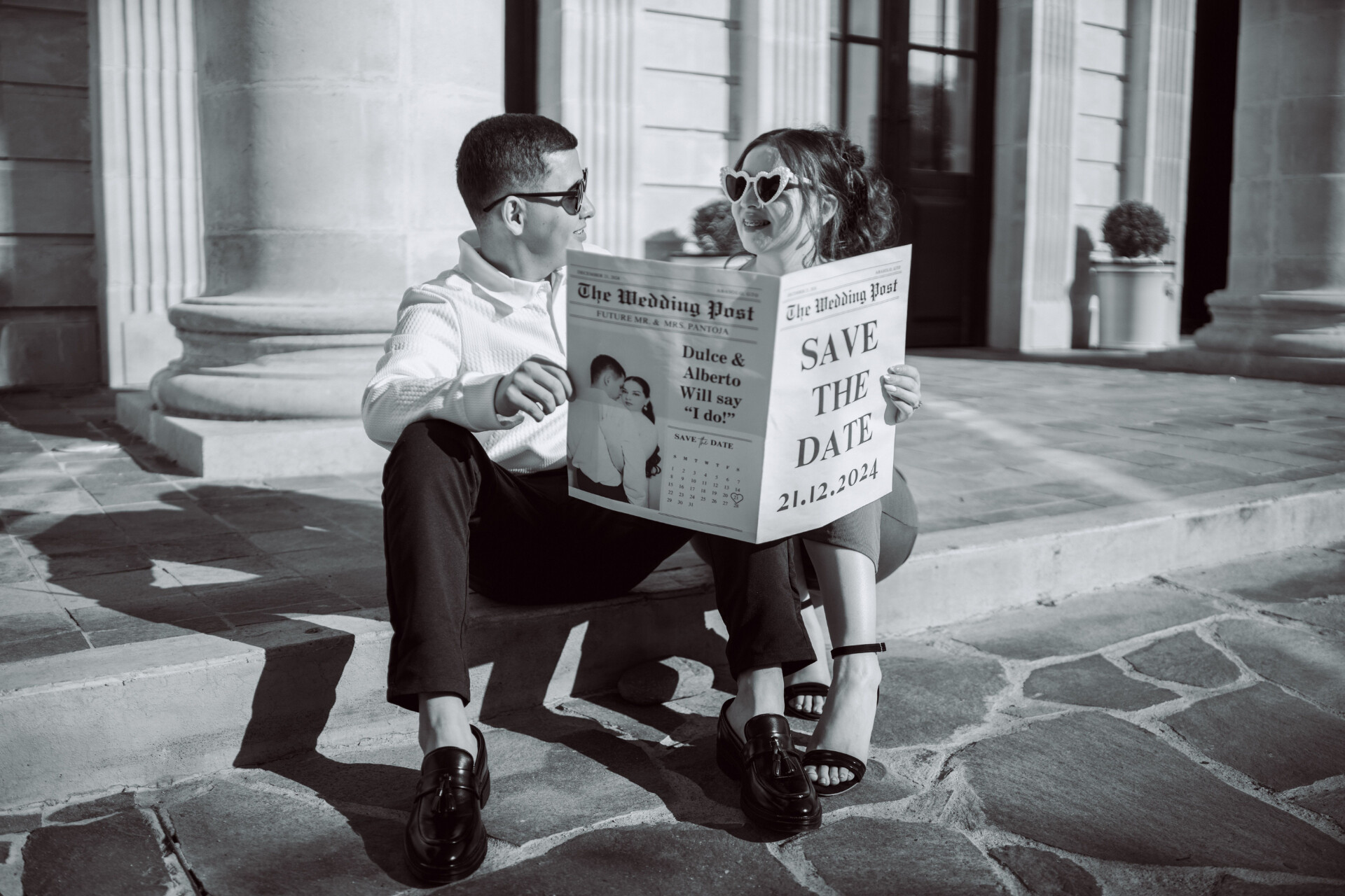 couple reading a "save the date" wedding newspaper