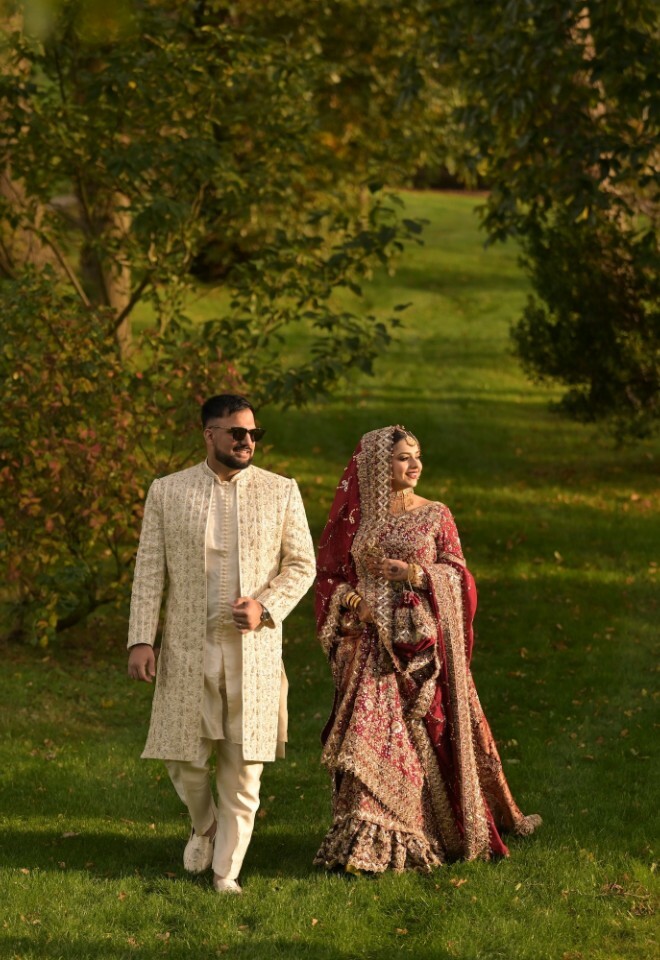 Bride and Groom strolling through the beautiful open grounds with trees around