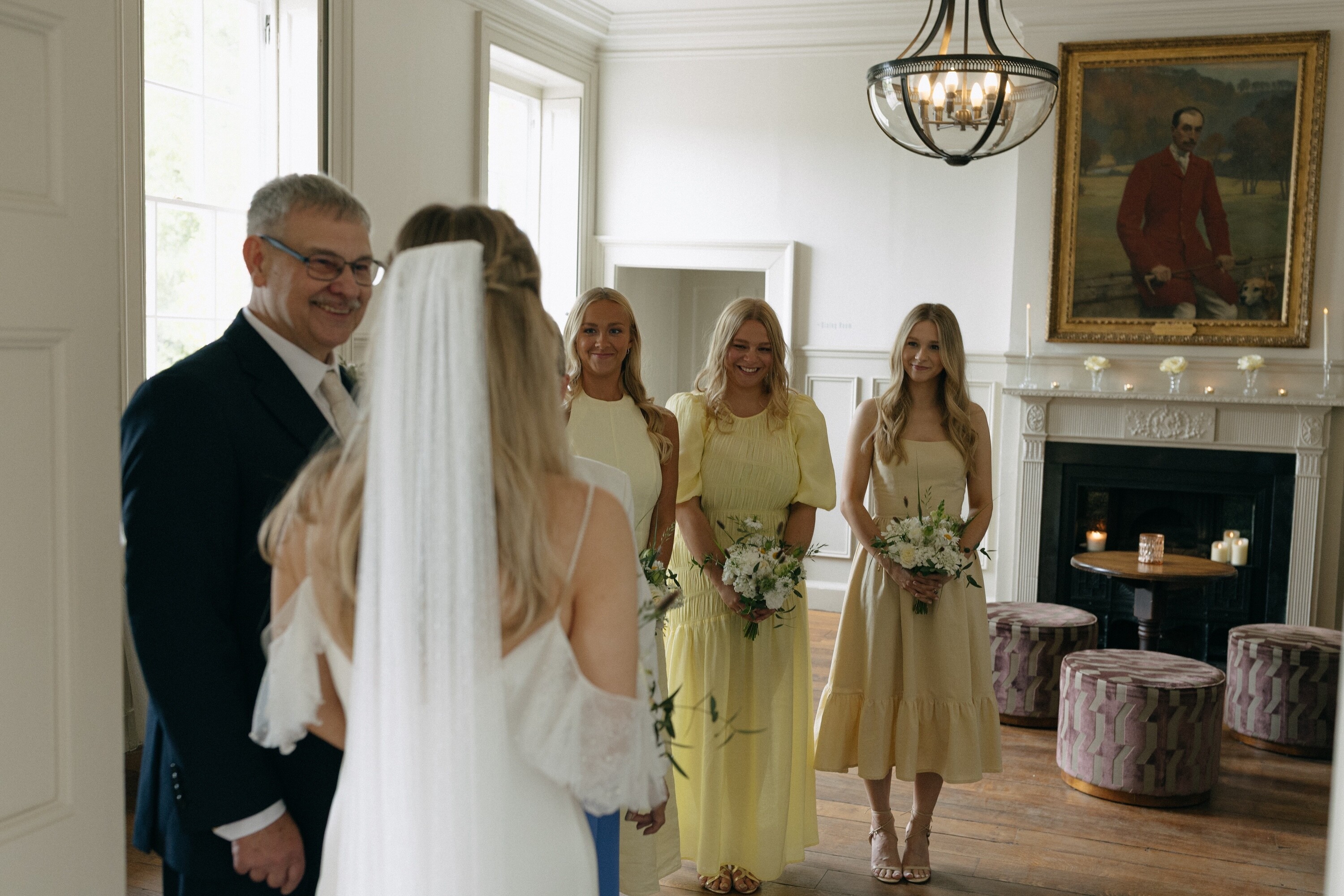 Bride with her bridesmaids in mismatched butter yellow bridesmaids dresses