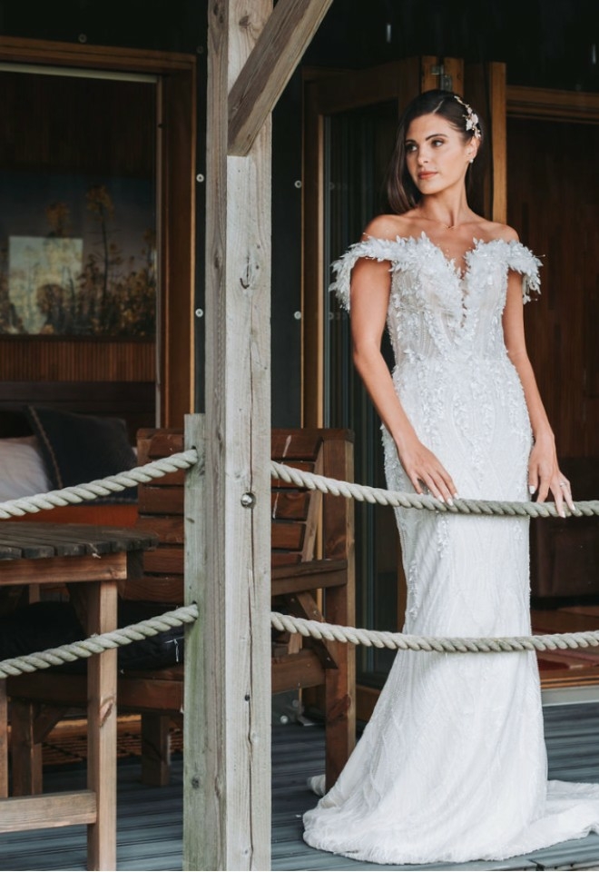 Bride posing and standing outside the lodge