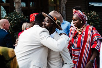 Groomsmen hugging after wedding ceremony