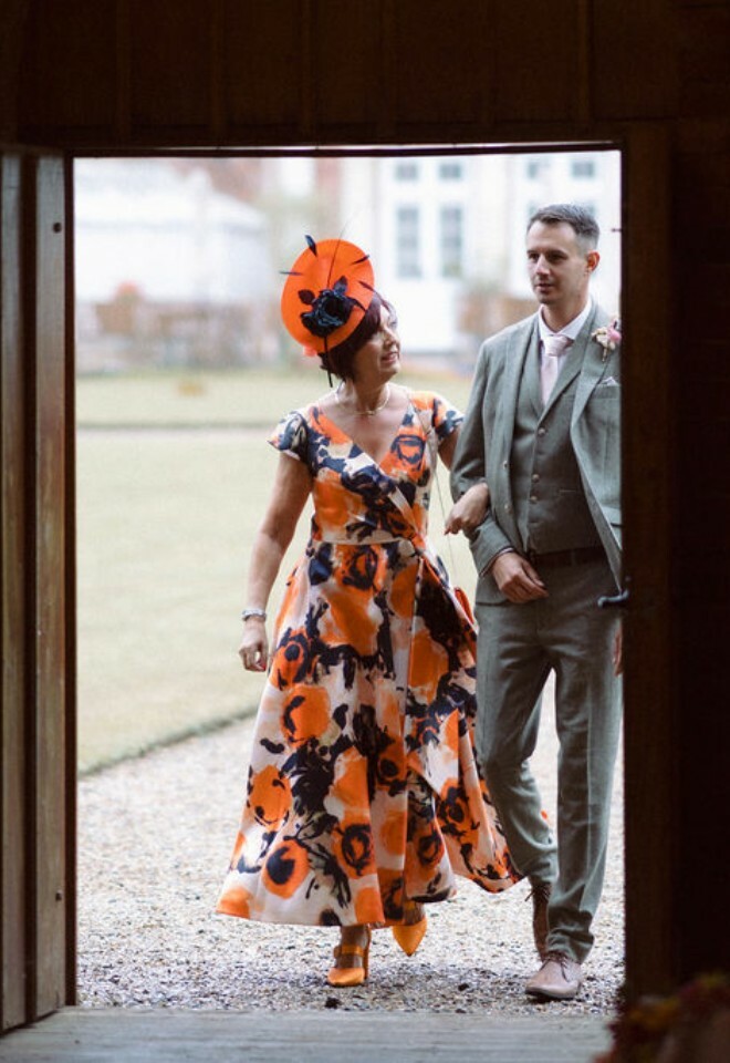 Brides mother is escorted into the ceremony by brides brother