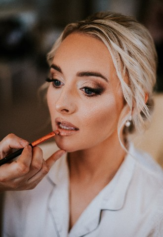 Bride getting makeup done at Hedsor House wedding venue Buckinghamshire