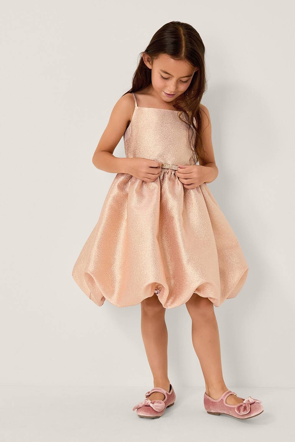 young girl in gold shimmer bubble dress