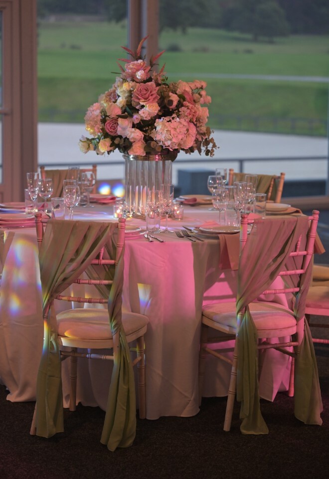 Beautiful floral table decor with pink light flashing on top of it