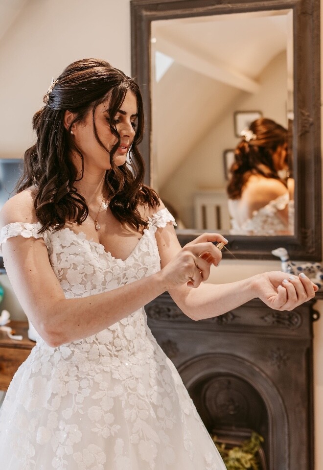 bride spraying herself with perfume getting ready shot