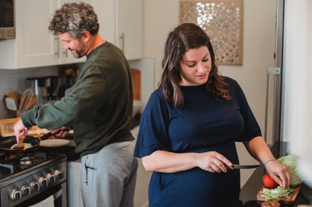 couple cooking together in the kitchen