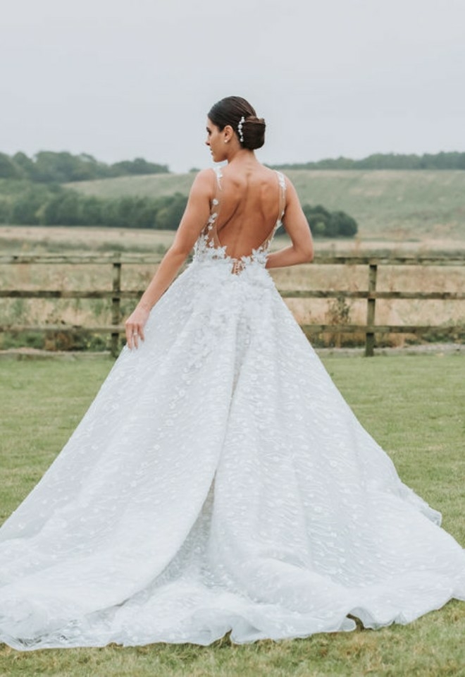 Bride with her hair up-done posing with the hills in the backdrop