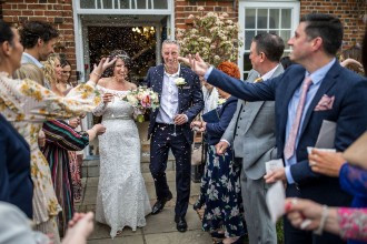 bride and groom showered with confetti